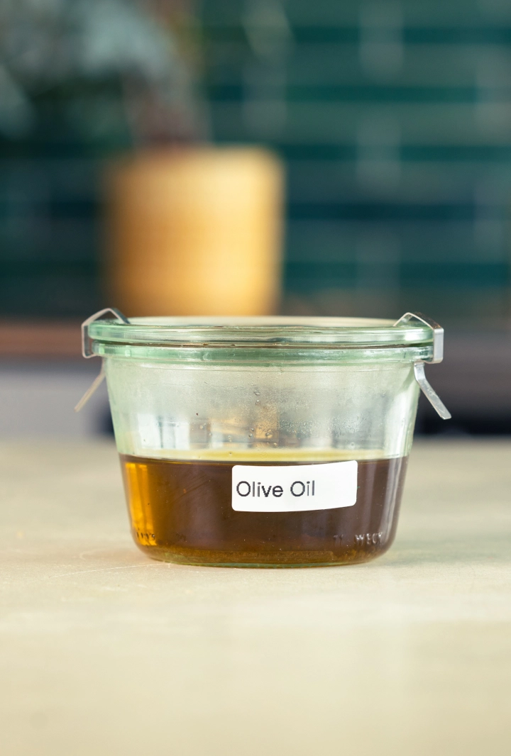 Opbevaring af cannabisinfuseret olivenolie Glasbeholder med cannabisinfuseret olivenolie, mærket og klar til opbevaring.